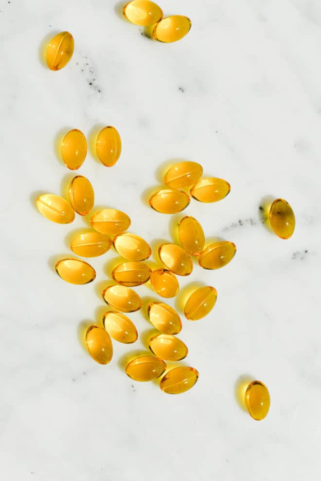 yellow cbd softgels on a marble surface