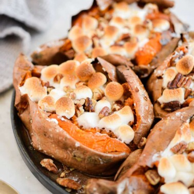 top view of a plate of marshmallow and pecan topped baked sweet potatoes