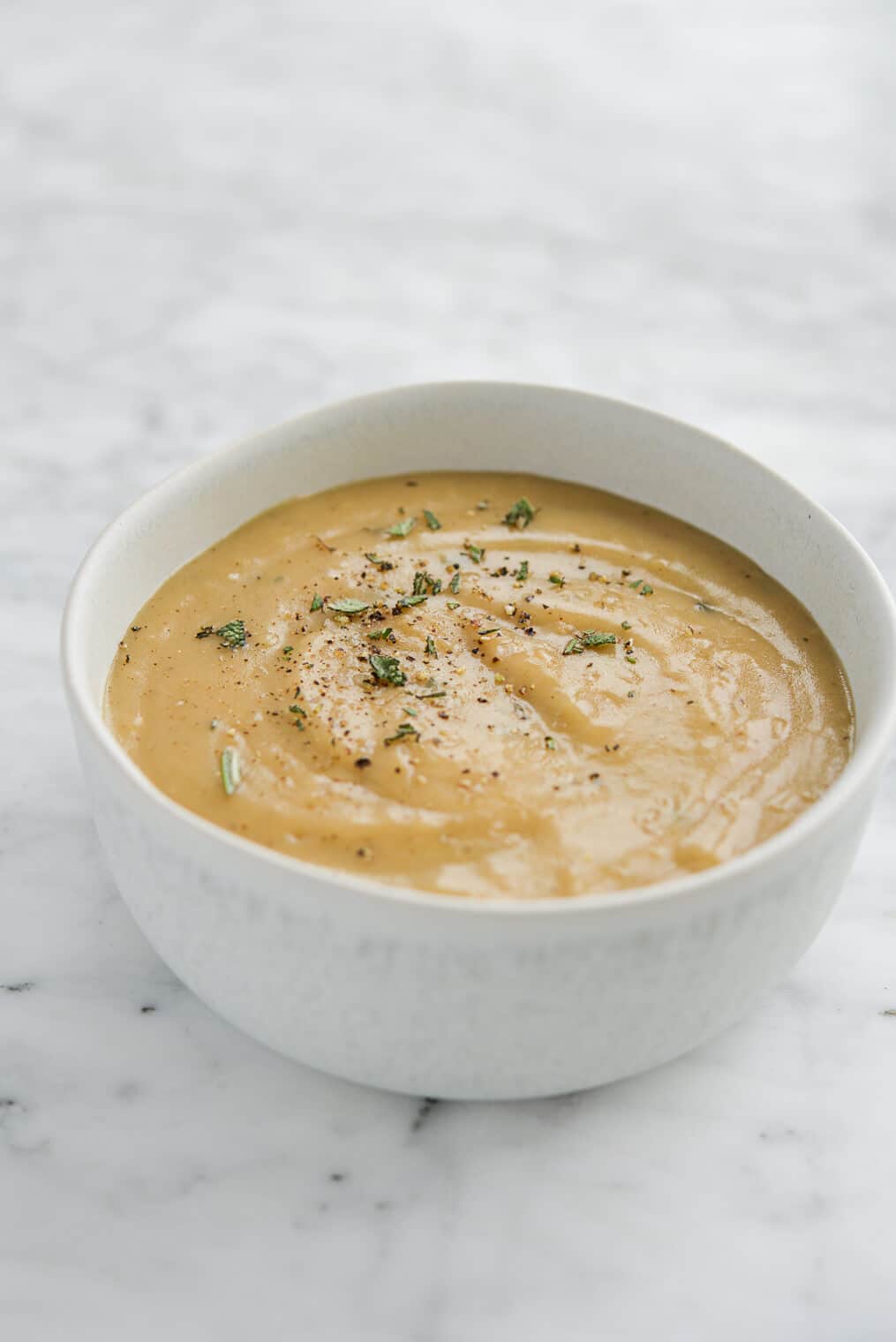 side view of a white bowl of classic gravy