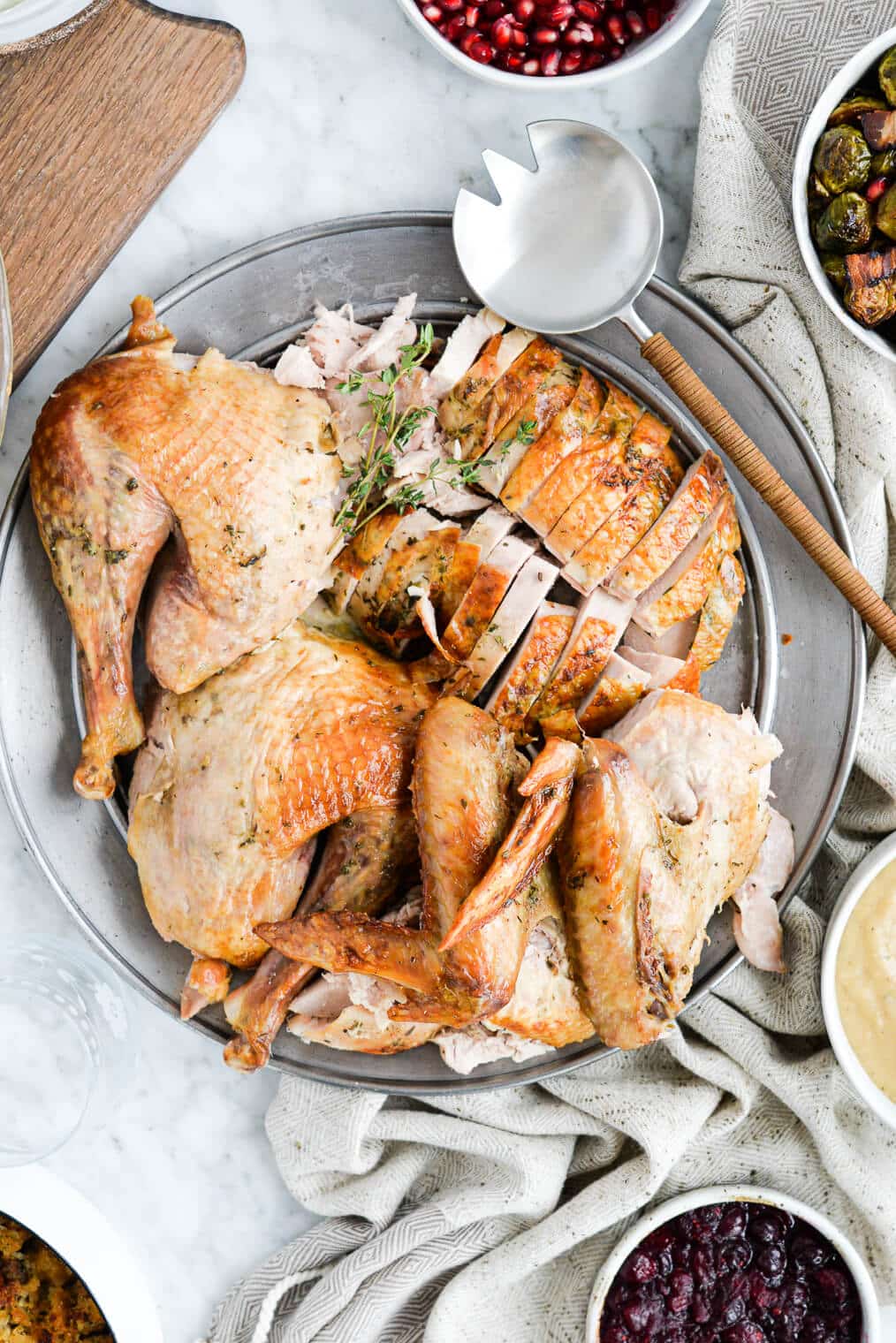 top view of a platter of carved and sliced whole roasted turkey