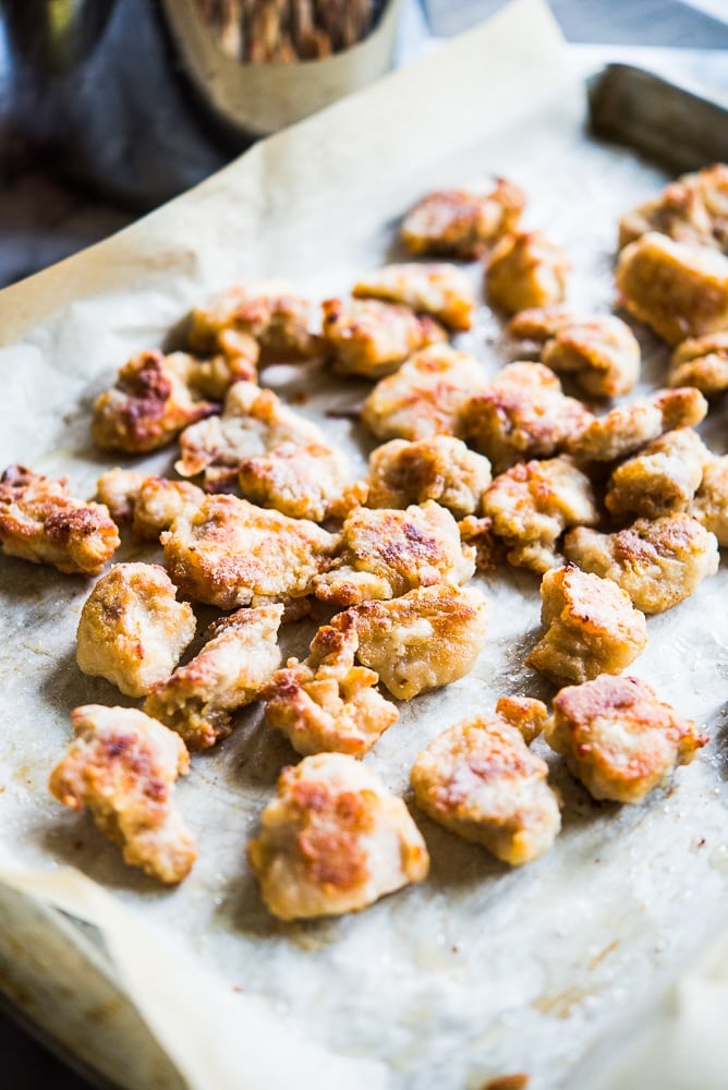 crispy coated chicken pieces on parchment paper