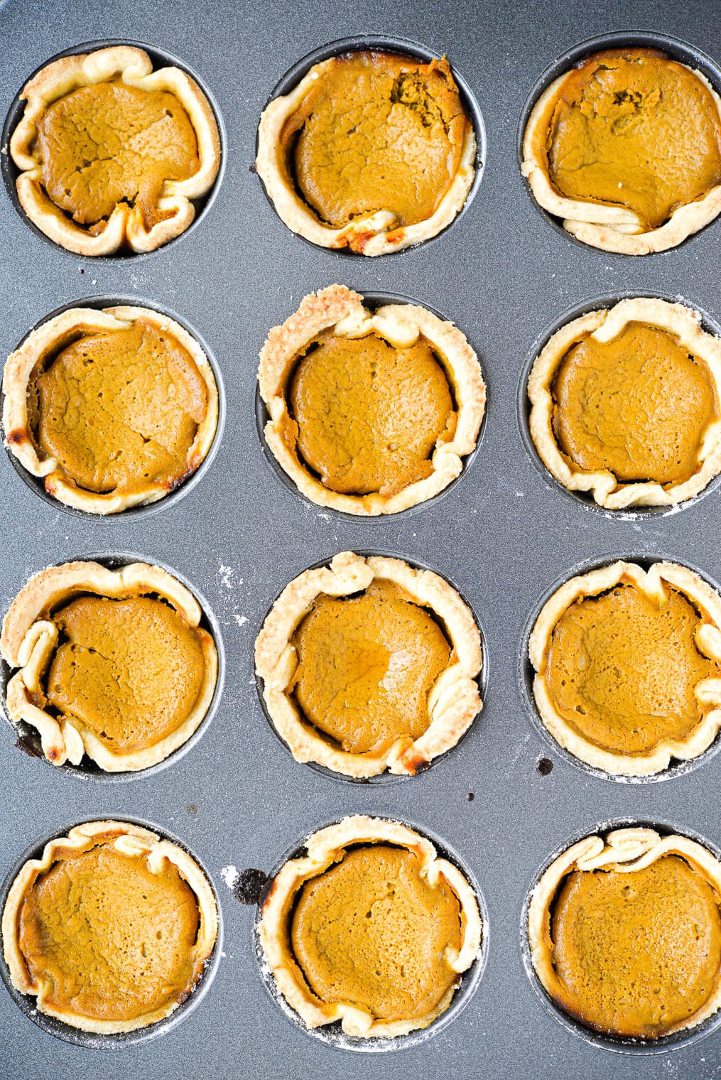 just baked mini pumpkin pies in a muffin tin