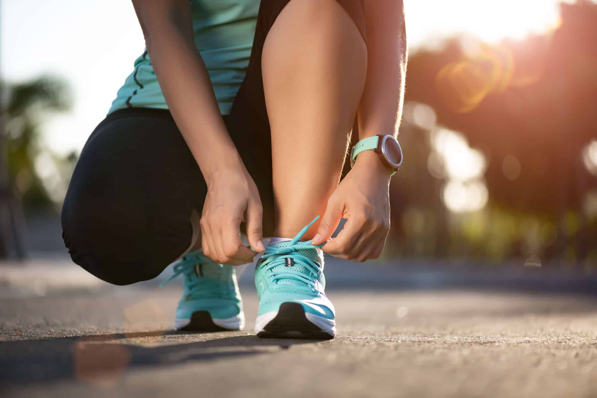 woman tying her blue sneakers