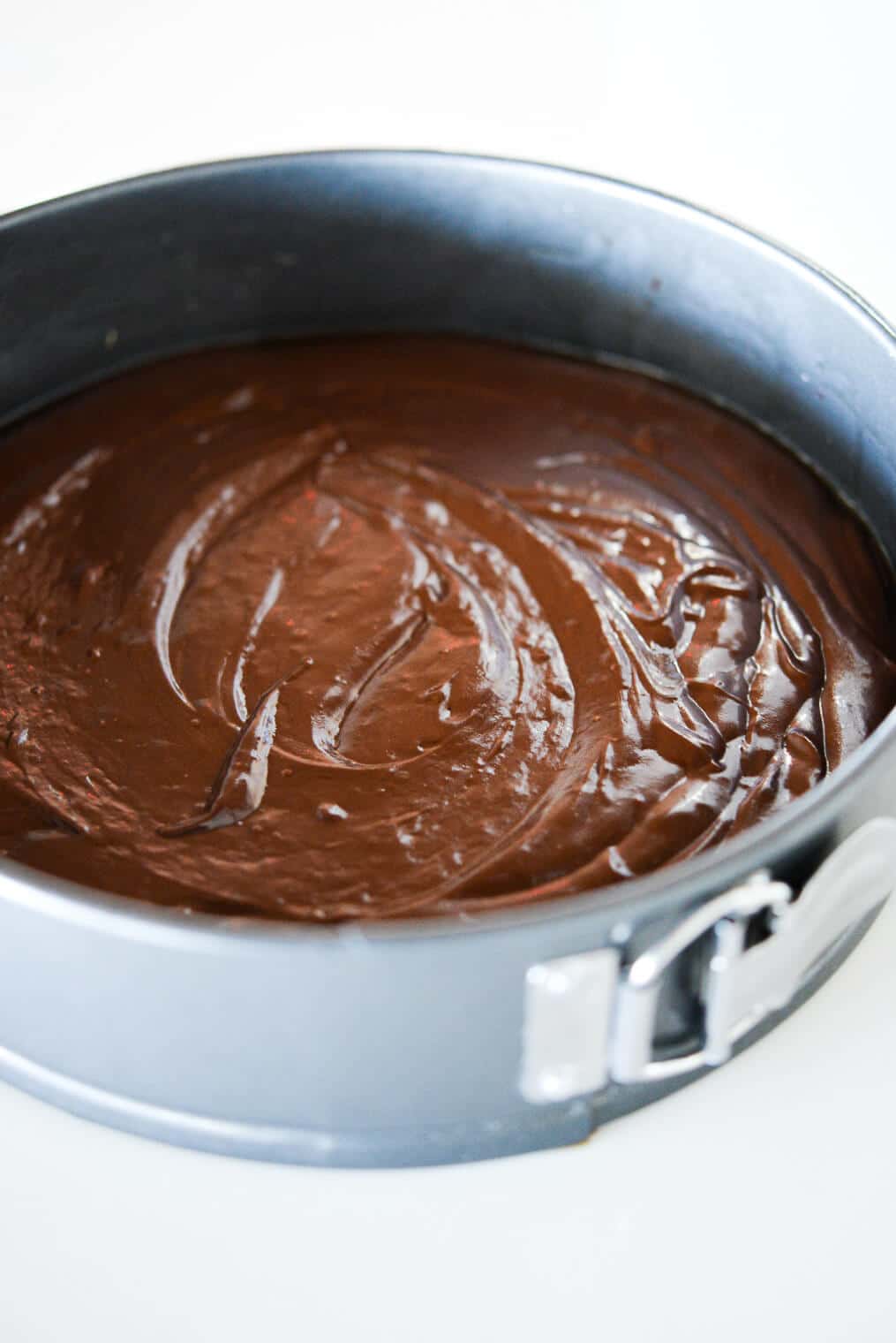 flourless dark chocolate cake batter in a springform baking pan
