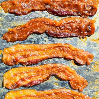7 slices of cooked, crispy bacon on a sheet pan