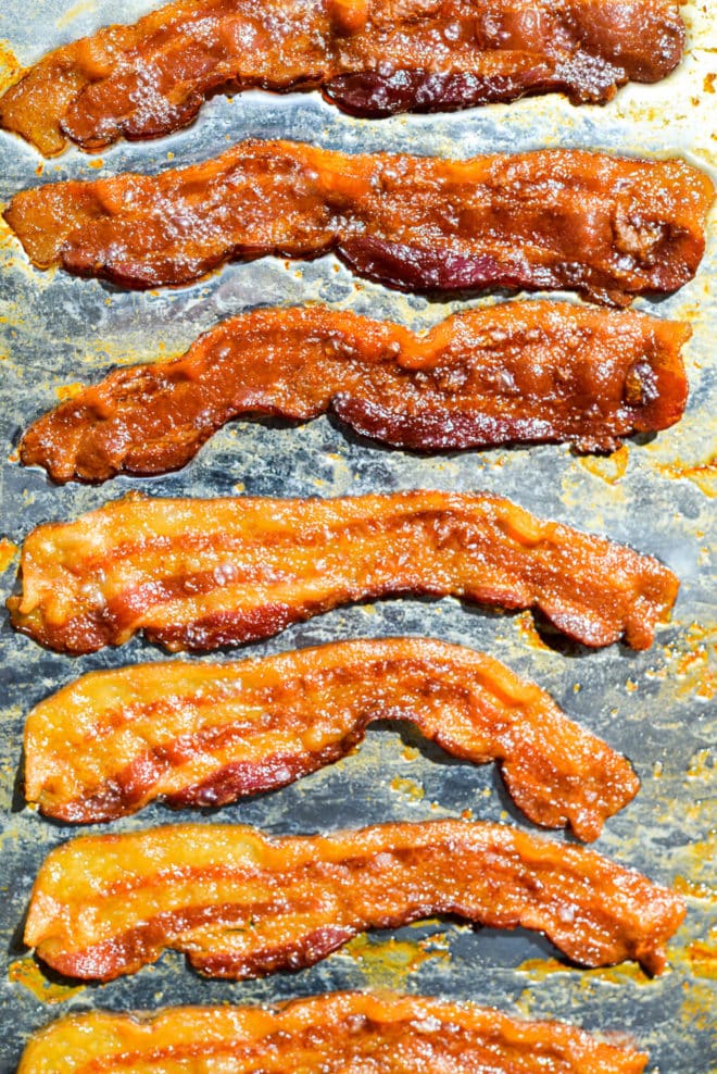 7 slices of cooked, crispy bacon on a sheet pan