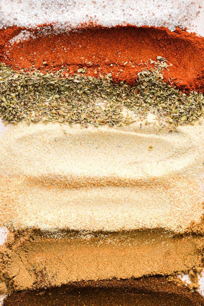 a pale pink rectangular plate with stripes of different seasonings