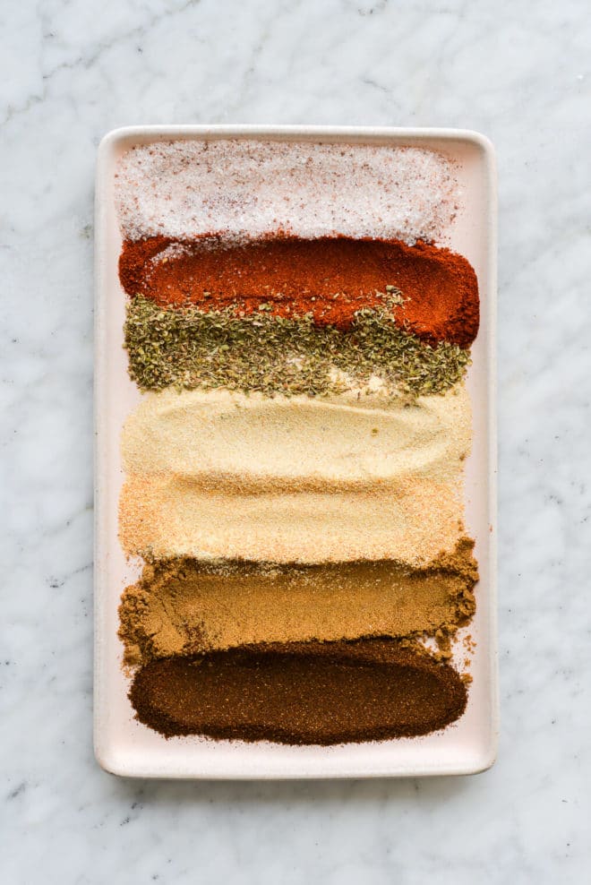 a pale pink rectangular plate with stripes of different seasonings