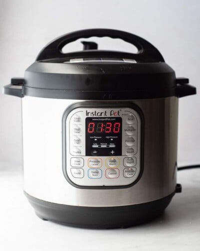 a front view of an instant pot set to cook on high pressure for 1 hour and 30 minutes