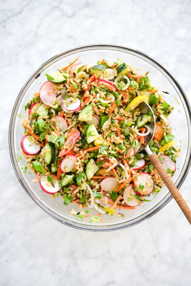 a large glass bowl of very colorful chilled spring veggie salad