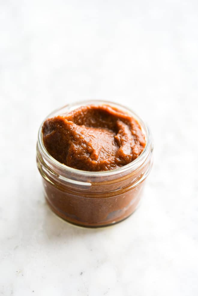 a small mason jar filled with tamarind paste