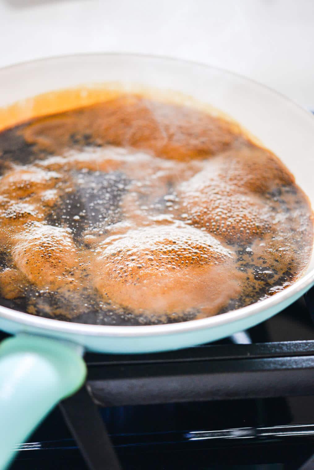 gluten free soy sauce bubbling in a pan on the stovetop
