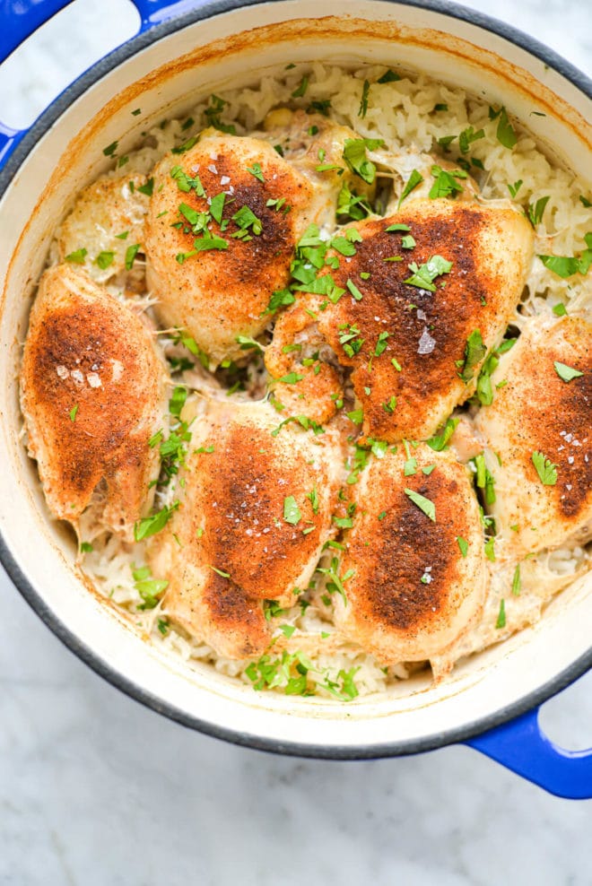 a finished enameled cast iron pot of cooked chicken and rice bake