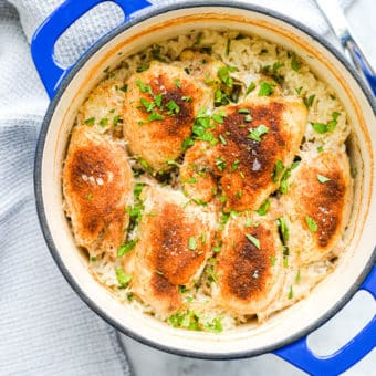 a finished enameled cast iron pot of cooked chicken and rice bake