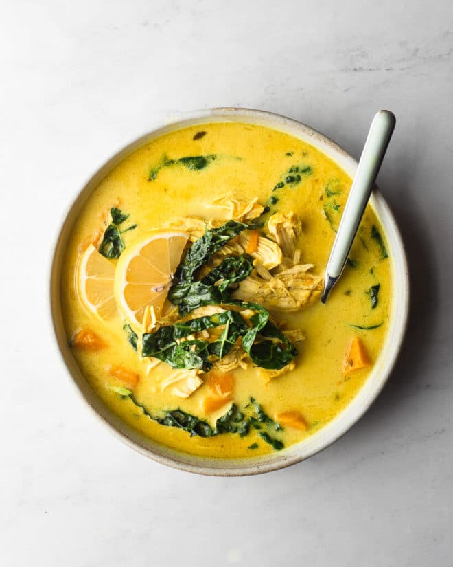 a bowl of healing turmeric soup with a spoon sticking out of it