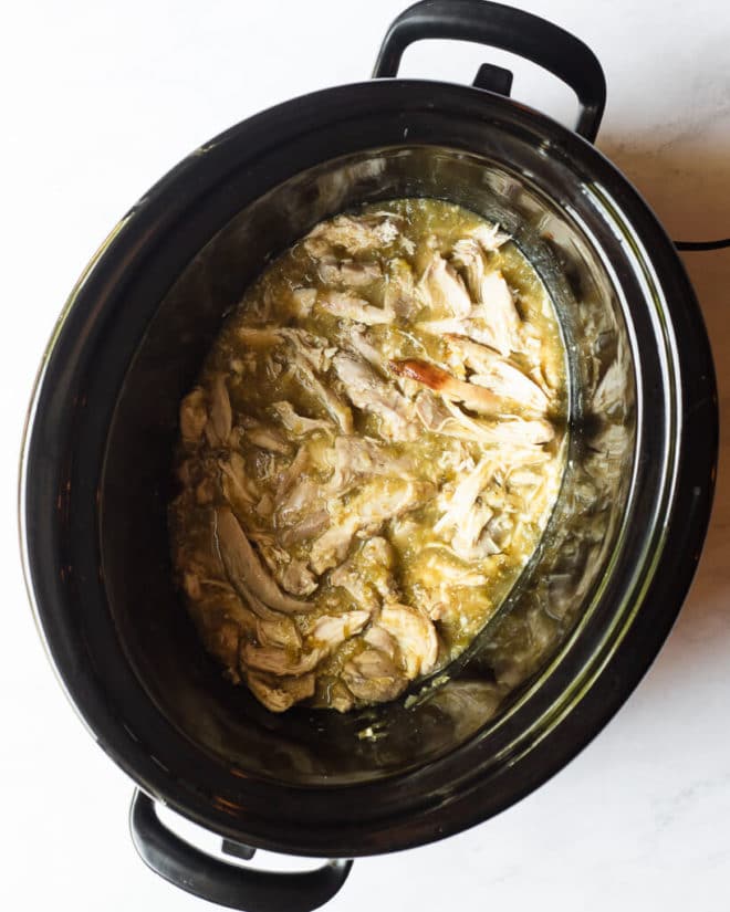 a cooked freezer meal in a slow cooker sitting on a marble surface