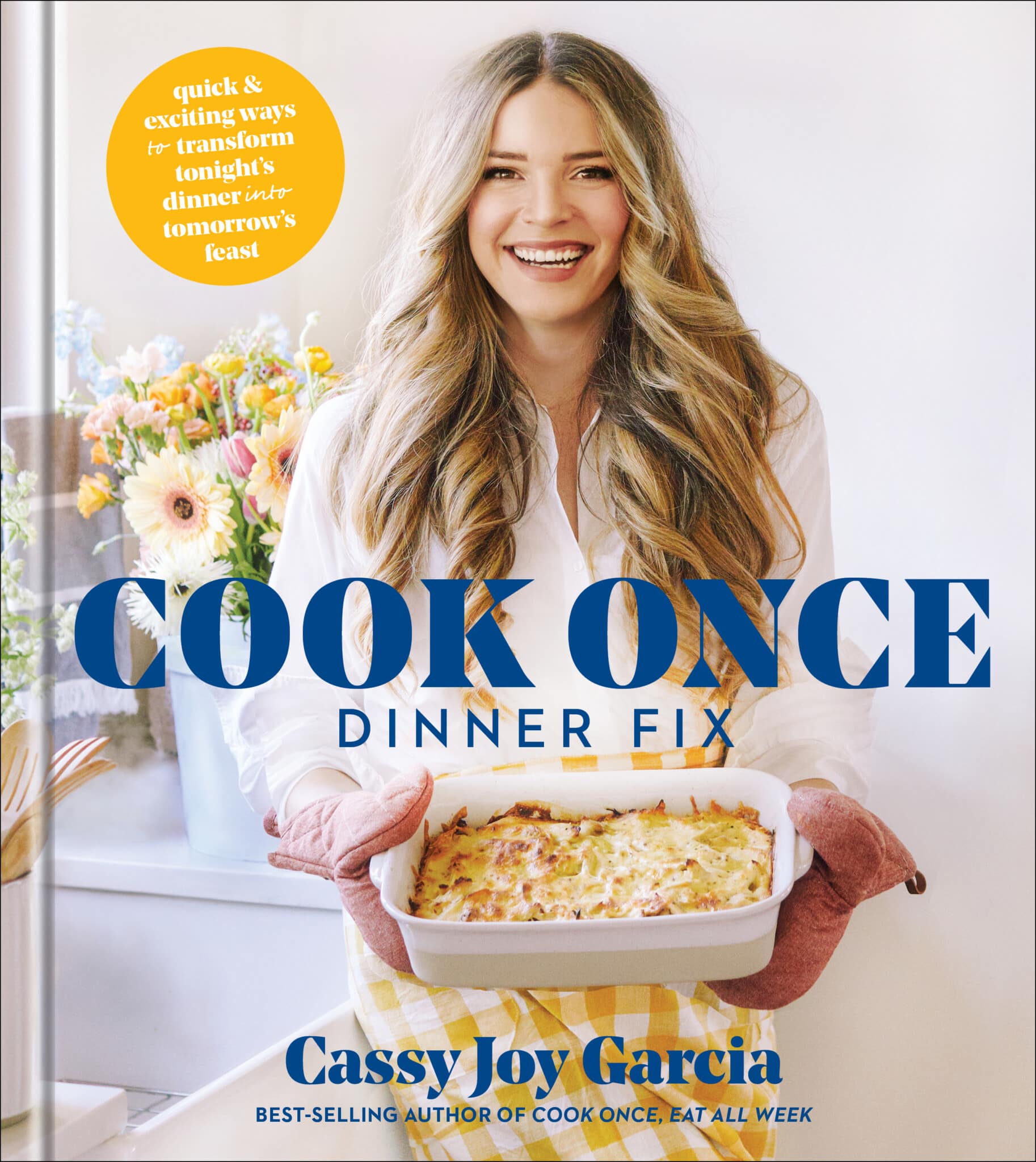 book cover with woman with light brown wavy hair in a white shirt holding a casserole dish with cook once dinner fix written in navy on the cover
