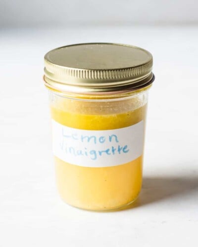 a small mason jar filled with a yellow liquid labeled "lemon vinaigrette"