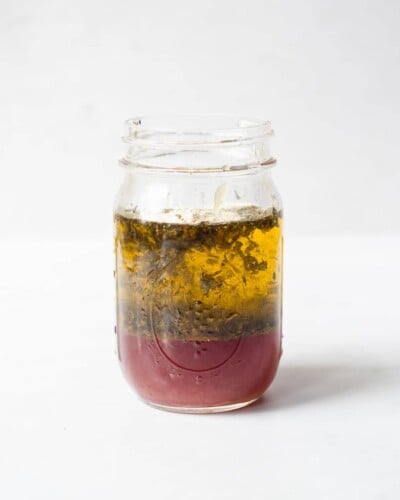 a mason jar of homemade Greek dressing before being mixed together
