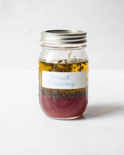 a mason jar of homemade Greek dressing before being mixed together