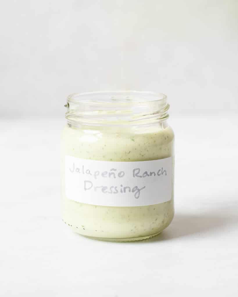 a small labeled jar filled with jalapeno ranch dressing