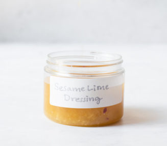 a small labeled jar filled with homemade sesame lime dressing