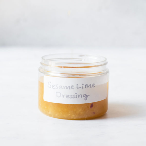 a small labeled jar filled with homemade sesame lime dressing