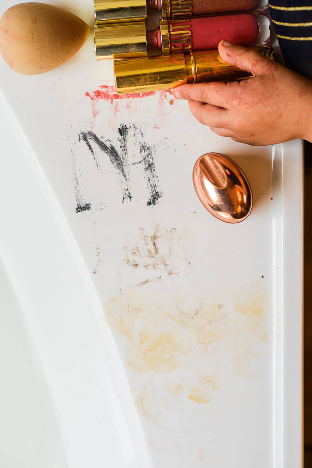 a bathroom tub covered on makeup smears