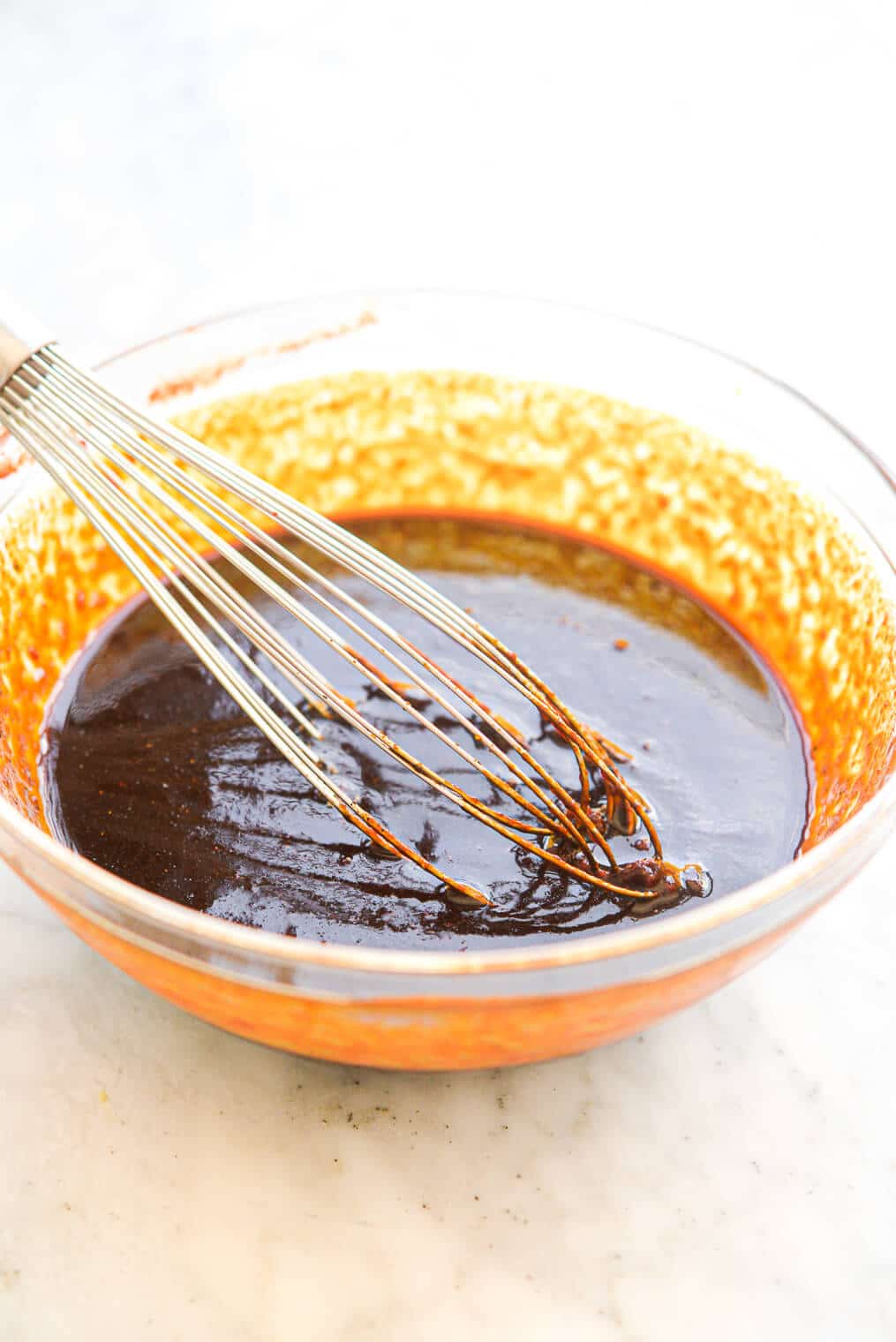a large glass bowl of whisked classic bbq sauce