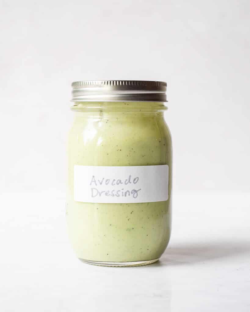 a labeled jar of avocado dressing