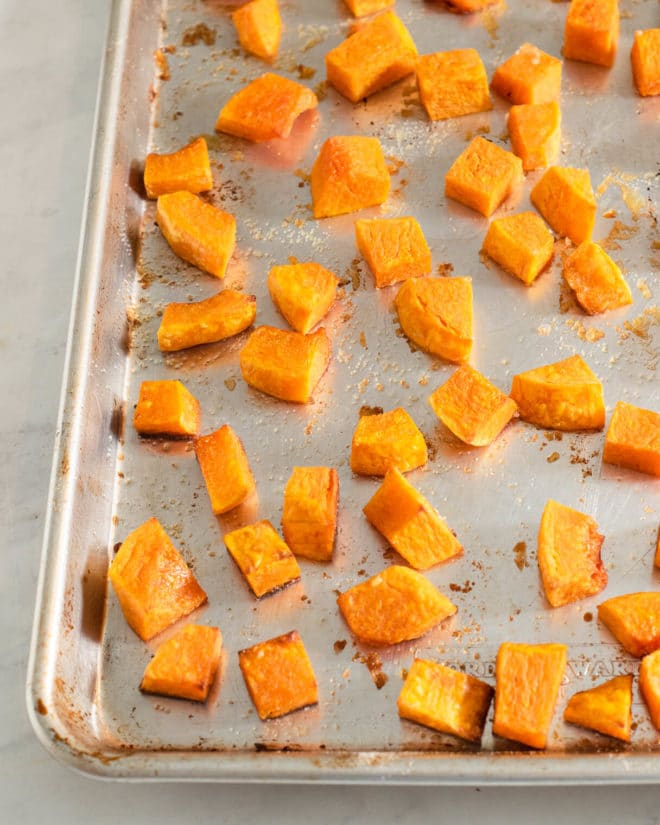 cubed, roasted butternut squash on a sheet pan