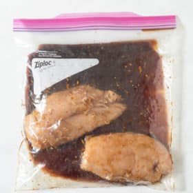 2 raw chicken breasts in a large ziplock bag of grilled chicken marinade