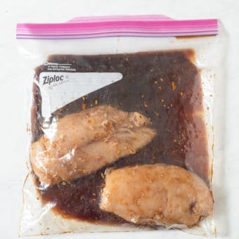 2 raw chicken breasts in a large ziplock bag of grilled chicken marinade