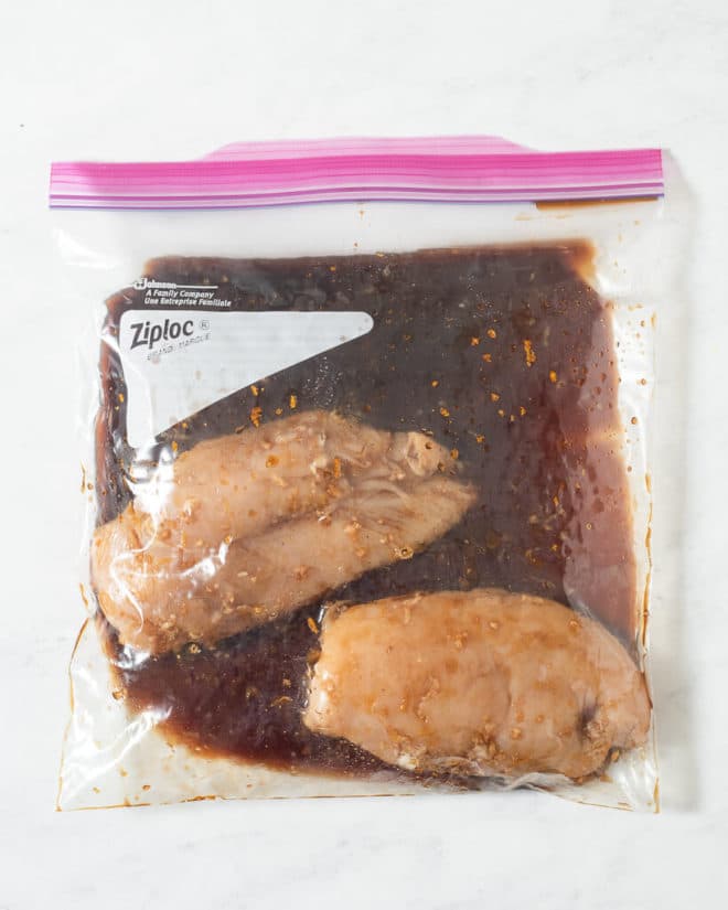 2 raw chicken breasts in a large ziplock bag of grilled chicken marinade