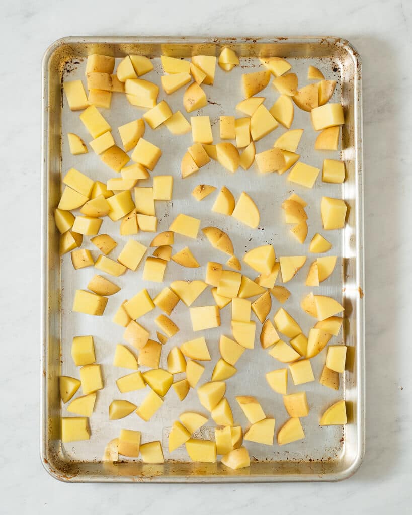a sheet pan of cubed potatoes