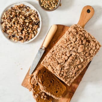 a loaf of pumpkin bread on a cutting board next to a knife