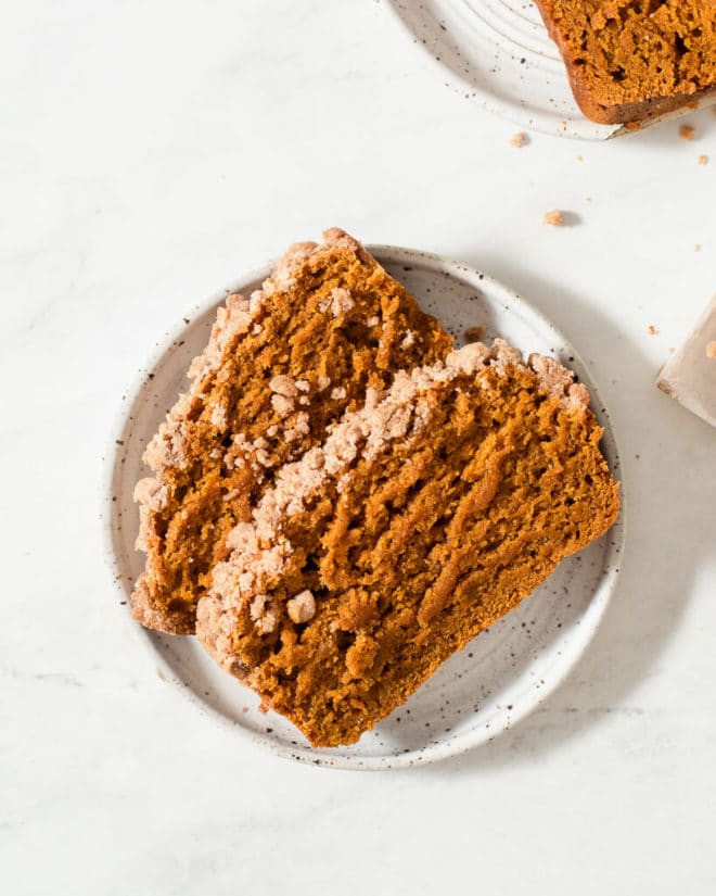 two slices of vegan pumpkin bread on a plate