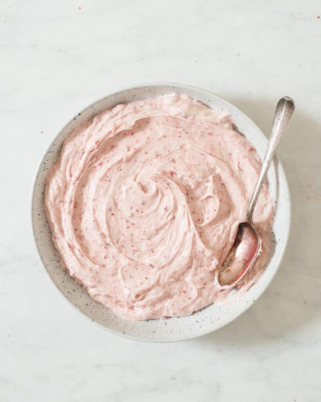 a bowl of strawberry cream cheese frosting in a bowl