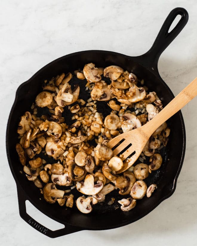 the makings of mushroom gravy in a cast iron skillet