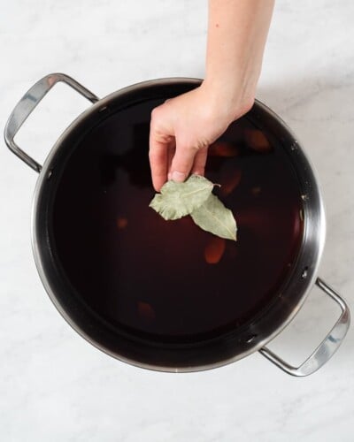 all of the ingredients for a pork chop brine in a large stainless steel pot