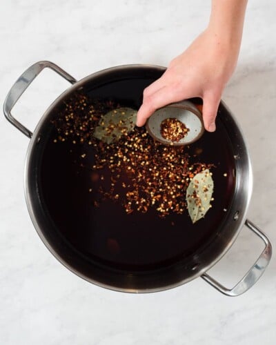 all of the ingredients for a pork chop brine in a large stainless steel pot