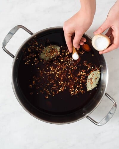 all of the ingredients for a pork chop brine in a large stainless steel pot