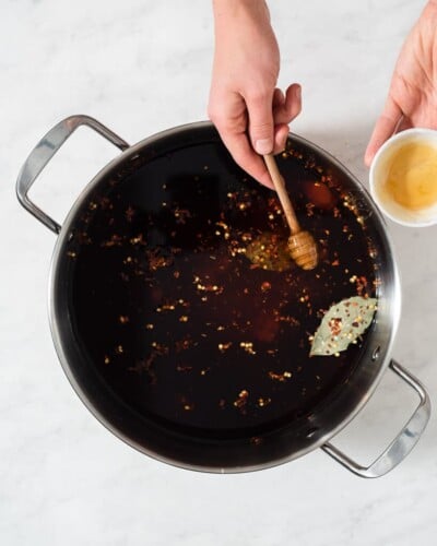 all of the ingredients for a pork chop brine in a large stainless steel pot