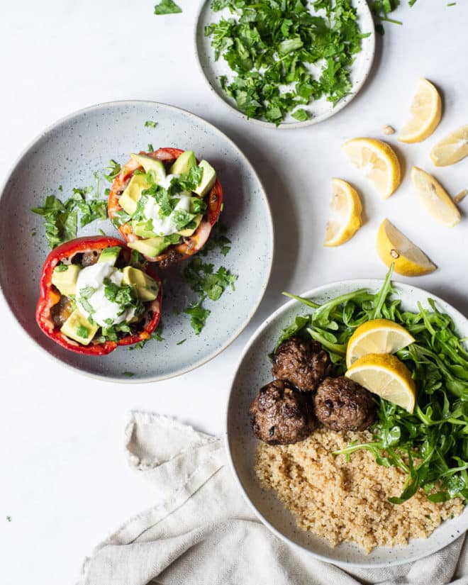 a serving of tex mex stuffed peppers and greek meatballs on plates