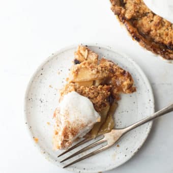 a piece of dutch apple pie with whipped cream on top