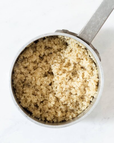 a stainless steel pot of cooked white quinoa