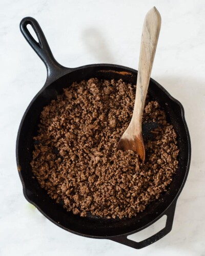 a cast iron skillet of browned tex mex ground beef