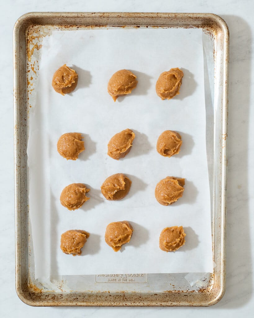 3 ingredient peanut butter cookies on a parchment lined pan before going into the oven