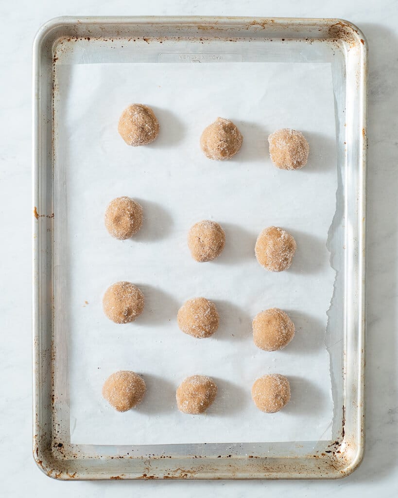 vegan pb cookies on a parchment paper lined cookie sheet