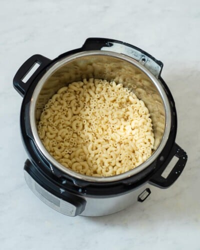an instant pot filled with cooked macaroni noodles